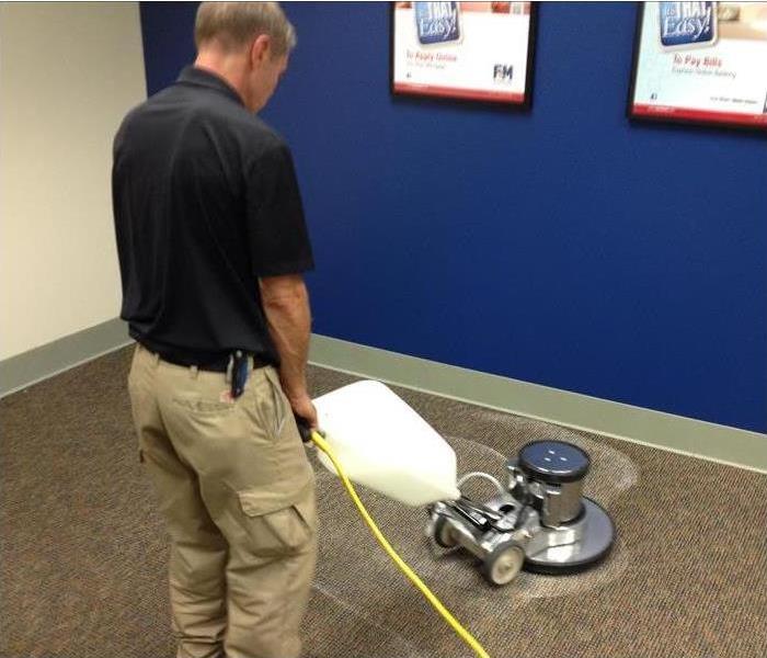 Worker cleaning carpets