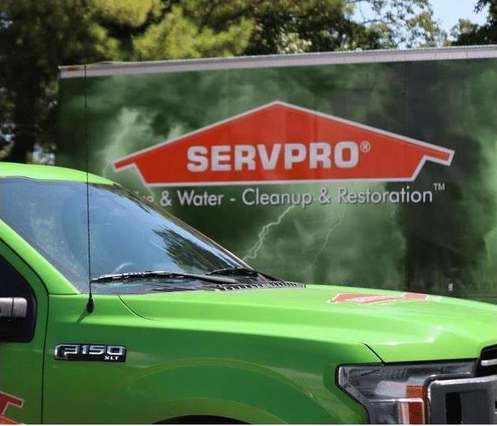 SERVPRO of Tampa Southeast logo on a box truck behind a SERVPRO green truck