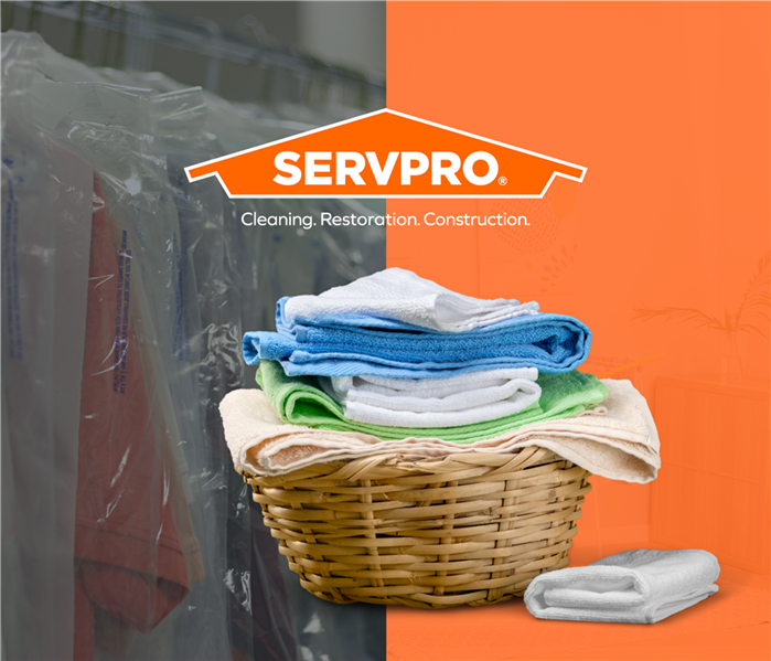 laundry basket with clothes, overlaying a an orange split background, left side is dry cleaning hangers, center SERVPRO logo